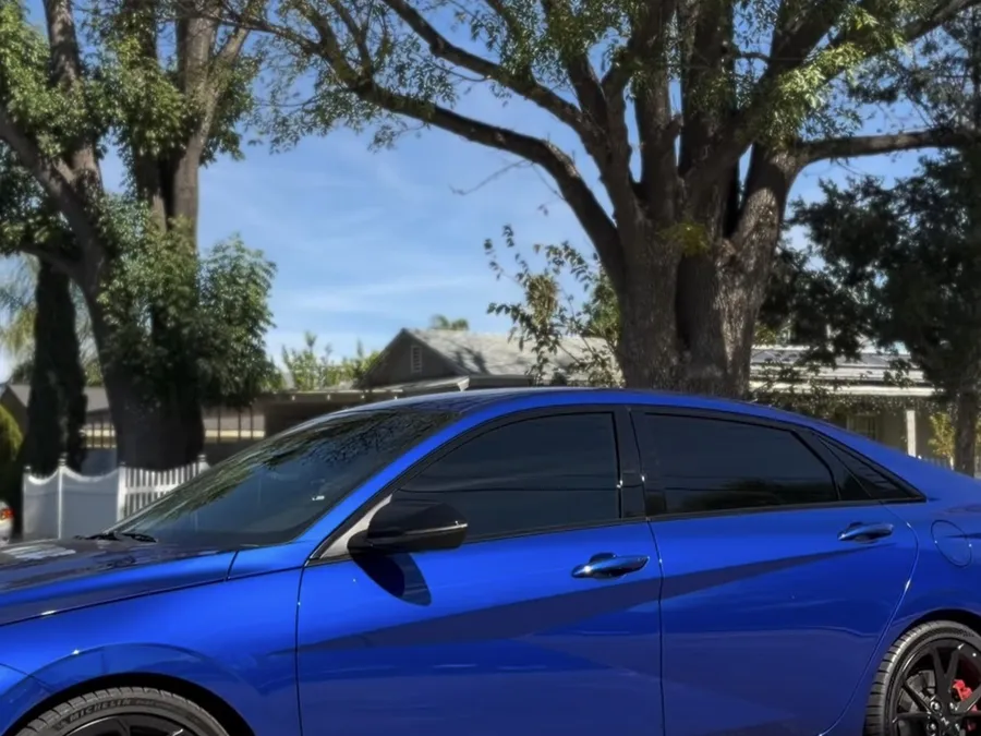 Blue sedan with dark ceramic tint on all windows