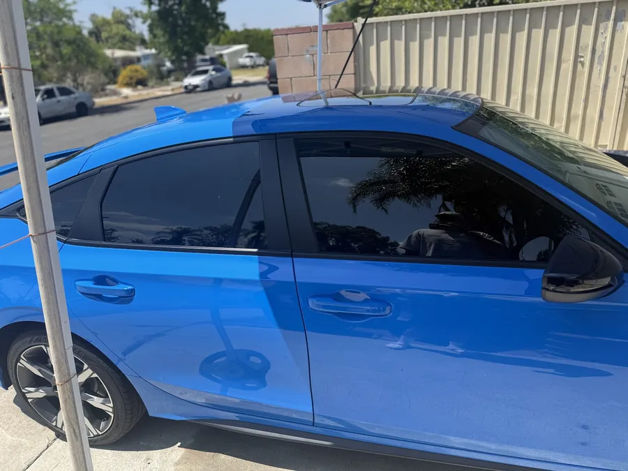 Close view of ceramic tint on a blue hatchback